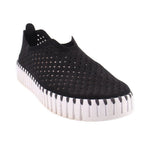 Black cutout slip-on flats with perforated upper and white ribbed sole trim