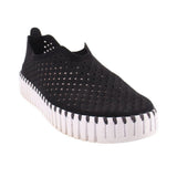 Black cutout slip-on flats with perforated upper and white ribbed sole trim