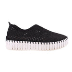 Black cutout slip-on flats with perforated pattern and striped white outsole edge