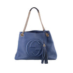GUCCI Soho chain tote bag in blue leather with embossed logo, tassel, and gold chain handles.