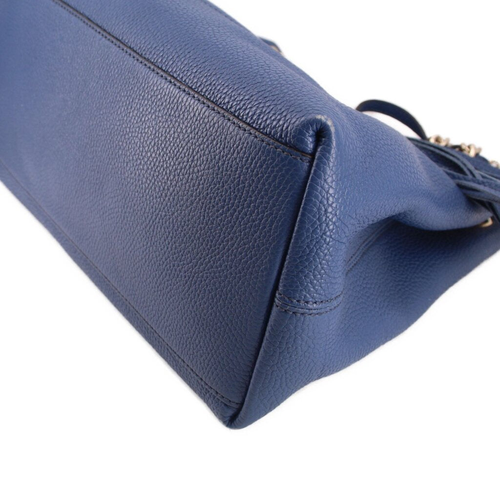Blue leather GUCCI Soho chain tote bag corner close-up with stitched seam detail.
