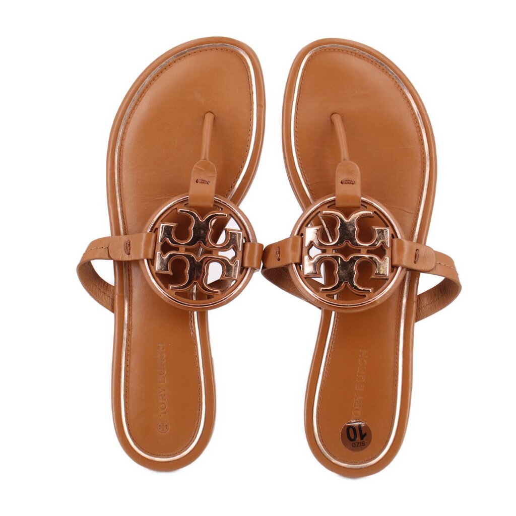 Tan slide sandals with adjustable thong strap and TORY BURCH logo ornament