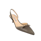 Green leather slingback heels with pointed toe, sling strap, and low kitten heel