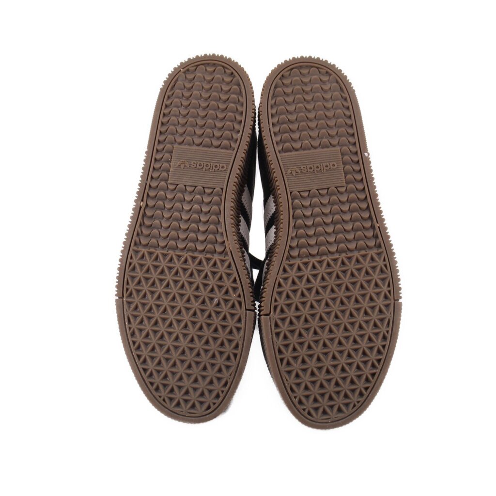 Pair of gum rubber outsole soles with textured tread on black sneakers