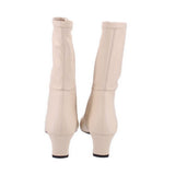 Cream leather knee-high boots, back view, with stitched seams and low stacked heel