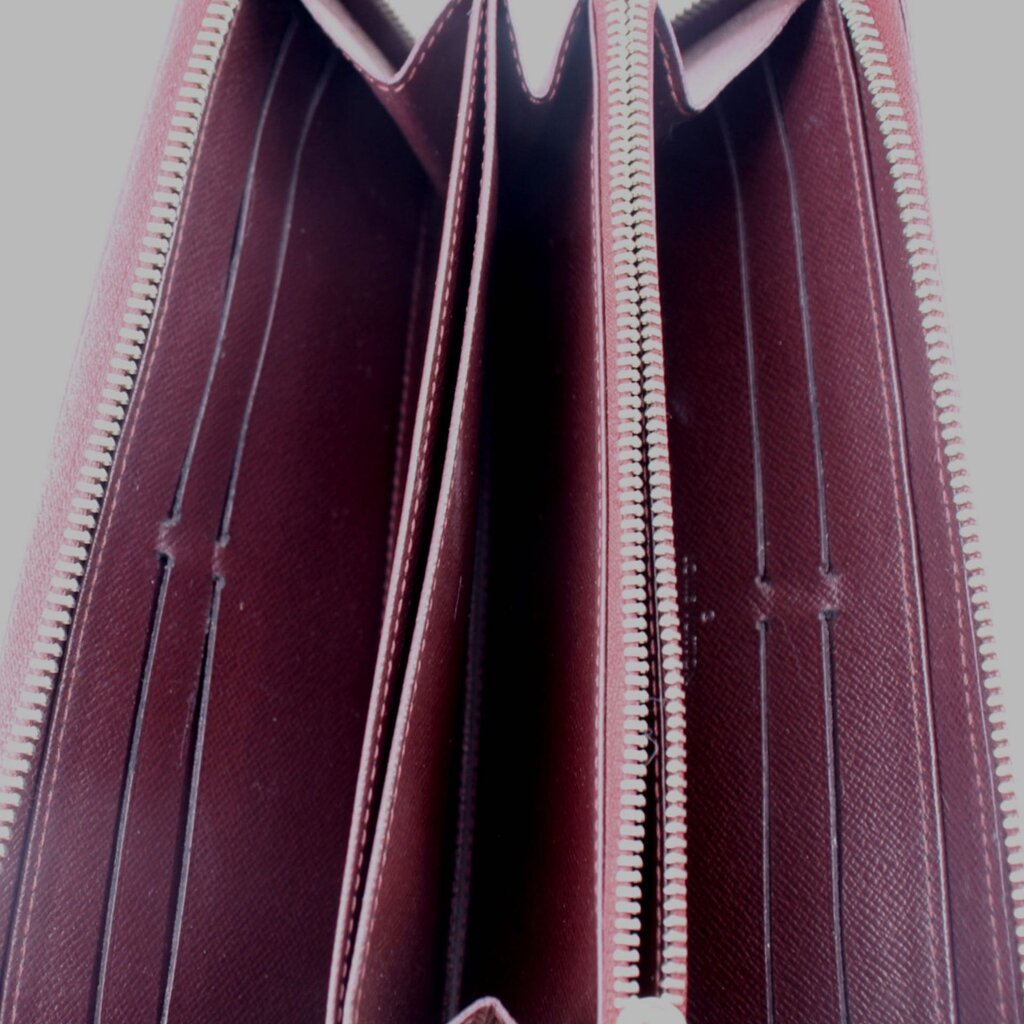 Epi zip wallet interior view with burgundy lining and zip track