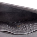Black interior lining of a small crossbody bag with visible stitching
