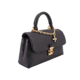 Black monogram flap crossbody bag with top handle, gold chain, and clasp