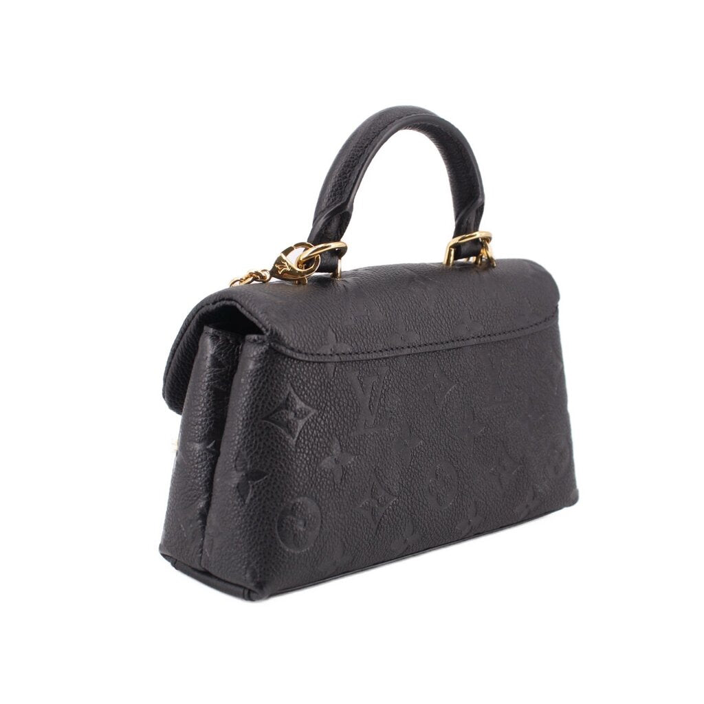 Black monogram mini flap crossbody bag with gold chain detail and structured sides