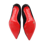 Black suede spike-heel pumps; red sole base visible from underside view