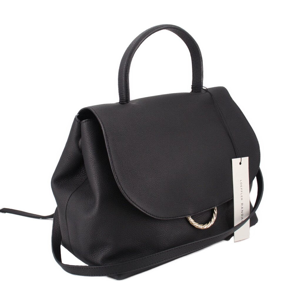 Carina crossbody bag with black flap, top handle, and adjustable shoulder strap.