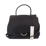 Black leather crossbody bag with top handle, flap front, and braided rope detail