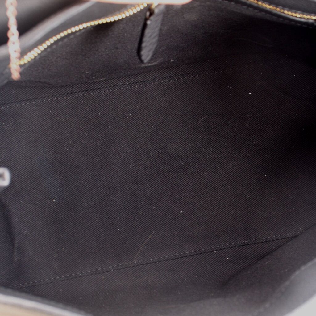 Carina crossbody bag interior with black fabric lining and visible zipper seam.