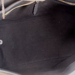 Carina crossbody bag interior with black fabric lining and visible zipper seam.