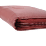 CHANEL red zip-around wallet close-up of stitched edge and zipper