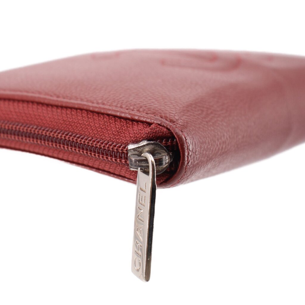 CHANEL red zip-around wallet side close-up with CHANEL zipper tag