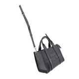 Small black leather tote bag with adjustable crossbody strap and top handles