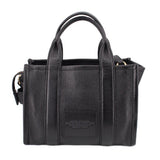 Small black leather tote bag with front center panel and top handles