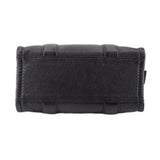 Small black leather tote bag with reinforced top flap and stitched detail