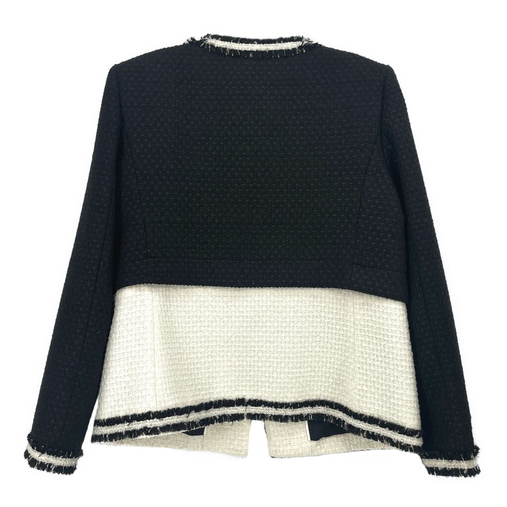 Black tweed jacket back view with cream panel and navy stripe trim, fringe cuffs