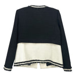 Black tweed jacket back view with cream panel and navy stripe trim, fringe cuffs
