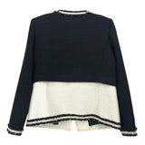 Black tweed jacket back view with cream panel and navy stripe trim, fringe cuffs
