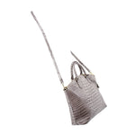Gray croc-embossed satchel with long shoulder strap and gold-tone hardware, angled