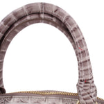 Gray croc-embossed satchel top handle and gold zipper close-up