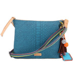 Teal snake-texture crossbody bag with tan straps and multicolor striped strap
