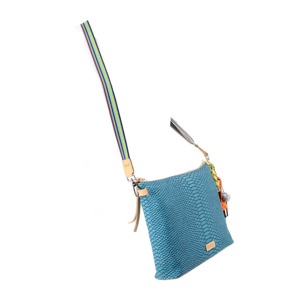 Small teal snake-texture crossbody bag with multicolor strap and dangling charms