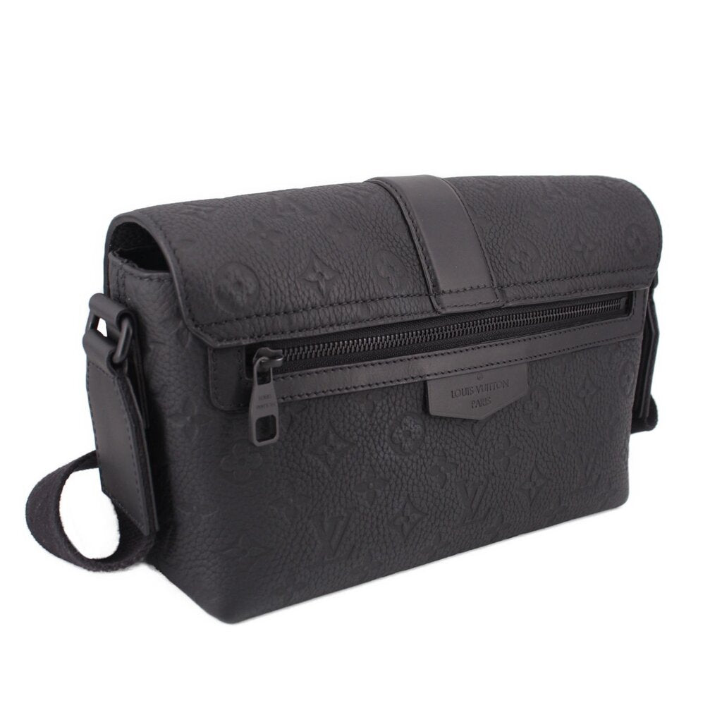 Black leather messenger bag with front zip pocket under flap and short strap