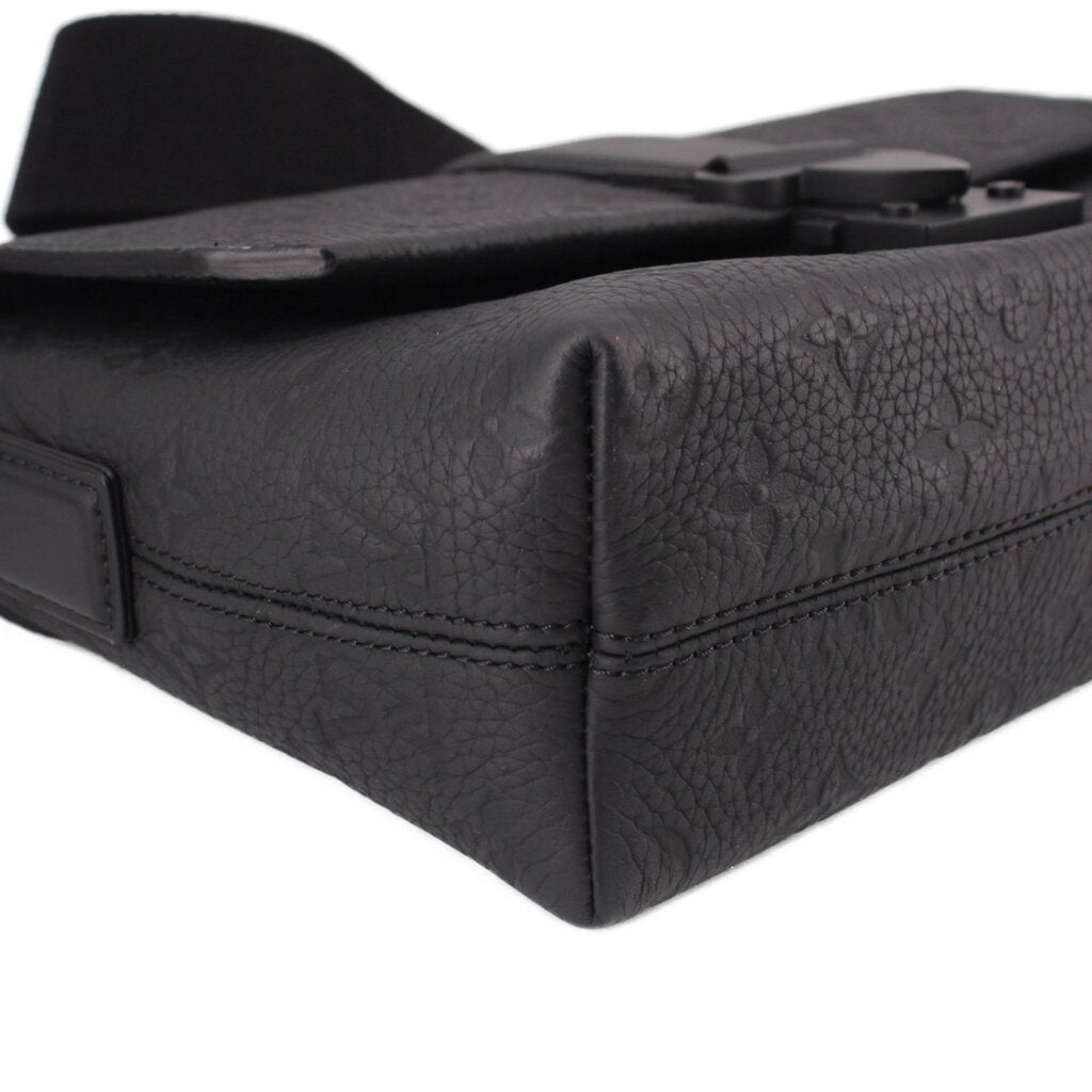 Black leather corner view of messenger crossbody bag with flap edge stitching