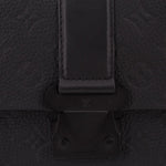 Black leather flap clasp and hardware detail on messenger crossbody bag