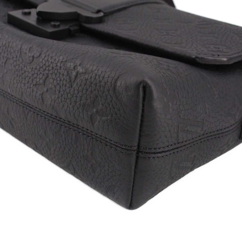 Black leather side view of messenger crossbody bag with flap seam detail