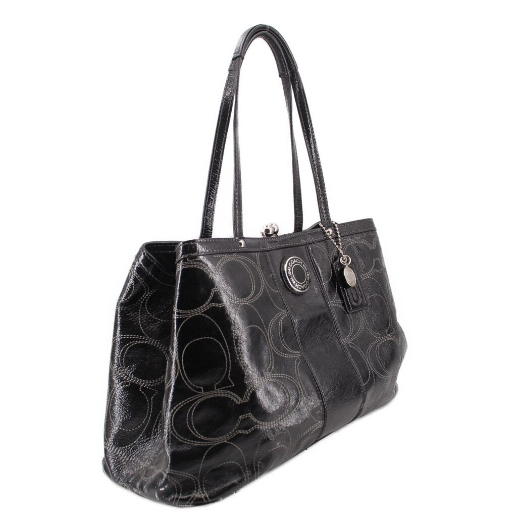 Black kisslock tote bag, angled view, patterned logo design and top handles