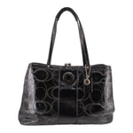 Black kisslock tote bag with patterned fabric and dual top handles