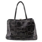Black patterned kisslock tote bag with round turn-lock clasp and handles