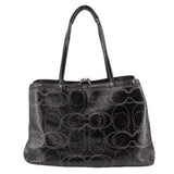 Black patterned kisslock tote bag with round turn-lock clasp and handles