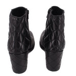 Black ankle boots with quilted diamond stitching on the back and block heel