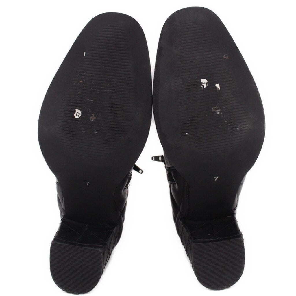 Black ankle boot outsoles with textured tread and block heels