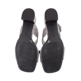 Pewter metallic leather sandals with black textured outsoles and attached ankle straps