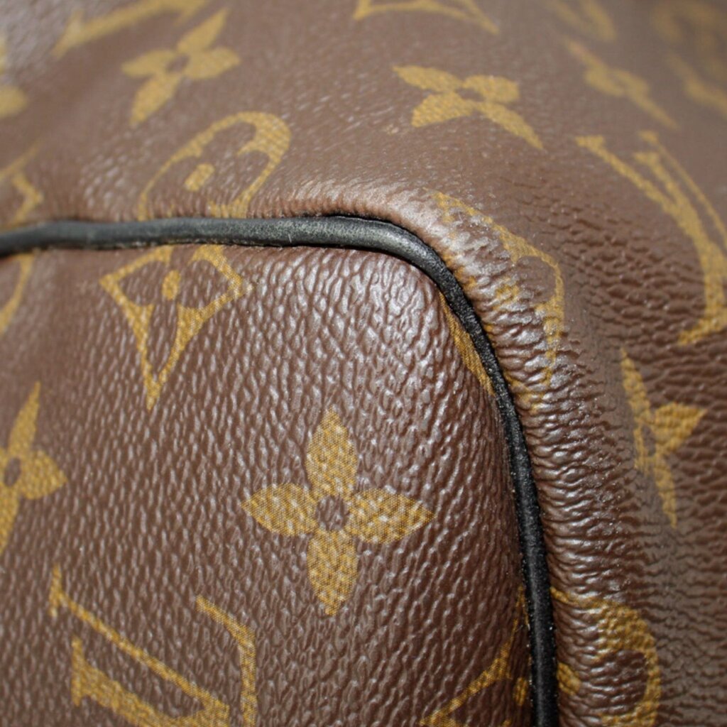 Monogram canvas edge close-up with black piping and textured leather trim