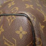 Monogram canvas edge close-up with black piping and textured leather trim