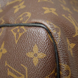 Monogram canvas edge close-up with black piping and textured leather trim
