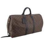Monogram duffel bag angled view with top handle, dark strap, and end patch panel