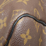 Monogram canvas corner close-up with black piping and reinforced leather border