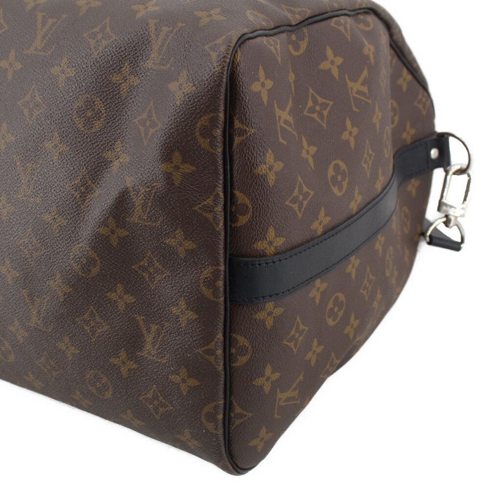 Monogram duffel corner detail with dark leather edge trim and shoulder strap clip