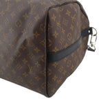 Monogram duffel corner detail with dark leather edge trim and shoulder strap clip
