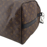 Monogram duffel corner detail with dark leather edge trim and shoulder strap clip