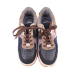 Pair of women’s sneakers with brown laces, cushioned collars, and padded tongue